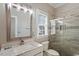 Bathroom featuring marble countertop, large mirror and a glass shower at 1412 Wynncrest Ct, Raleigh, NC 27603