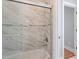 Bathroom featuring a marble-tiled shower with glass doors and chrome fixtures at 1412 Wynncrest Ct, Raleigh, NC 27603