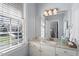 Bathroom with granite countertop, undermount sink and vanity with decorative mirror at 1412 Wynncrest Ct, Raleigh, NC 27603