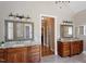 Bathroom with double vanity featuring granite countertops, and wood cabinets at 1412 Wynncrest Ct, Raleigh, NC 27603