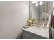 Bathroom with a light gray cabinet, marble countertop and decorative mirror at 1412 Wynncrest Ct, Raleigh, NC 27603