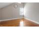 Bedroom with hardwood floors, a large window, and an antique clock on the wall at 1412 Wynncrest Ct, Raleigh, NC 27603