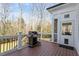 View of deck with outdoor grill and serene wooded backdrop at 1412 Wynncrest Ct, Raleigh, NC 27603