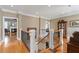 Foyer features hardwood floors, natural light and staircase with white banisters at 1412 Wynncrest Ct, Raleigh, NC 27603
