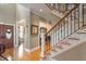 Elegant foyer with hardwood floors, staircase, and a view into the dining and living areas at 1412 Wynncrest Ct, Raleigh, NC 27603
