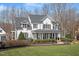 Charming home with a well-manicured lawn, beautiful landscaping, and a welcoming front porch at 1412 Wynncrest Ct, Raleigh, NC 27603