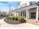 Welcoming front porch with elegant columns and double doors with decorative wreaths at 1412 Wynncrest Ct, Raleigh, NC 27603