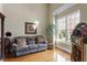 Inviting living room with hardwood floors, a large window, and comfortable seating at 1412 Wynncrest Ct, Raleigh, NC 27603