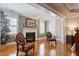 Cozy living room with fireplace, hardwood floors, recessed lighting, and two chairs at 1412 Wynncrest Ct, Raleigh, NC 27603