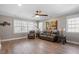 Comfortable living room with hardwood floors, ceiling fan, and plenty of natural light from the large windows at 1412 Wynncrest Ct, Raleigh, NC 27603