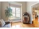 Bright living room featuring hardwood floors, a large window, and unique vintage jukebox at 1412 Wynncrest Ct, Raleigh, NC 27603