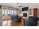 Comfortable living room with a fireplace, built-in shelves, and large windows at 1412 Wynncrest Ct, Raleigh, NC 27603