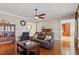 Spacious living room with hardwood floors, a ceiling fan, and a view into the kitchen at 1412 Wynncrest Ct, Raleigh, NC 27603