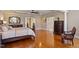 Bedroom features hardwood floors, an ornate mirror, and a dark wood dresser at 1412 Wynncrest Ct, Raleigh, NC 27603