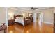 Bedroom features hardwood floors, tray ceiling, and an open doorway to another room at 1412 Wynncrest Ct, Raleigh, NC 27603