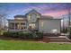 View of the back of the house with a screen porch, deck, and well-maintained landscaping at 1412 Wynncrest Ct, Raleigh, NC 27603