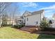 Rear view of a home with a screened porch, deck, and lush green backyard at 1412 Wynncrest Ct, Raleigh, NC 27603