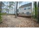 Exterior view showing large deck, backyard, and mature trees in the yard at 1701 Point Owoods Ct, Raleigh, NC 27604