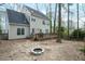 Exterior view showing backyard, mature trees and patio with fire pit at 1701 Point Owoods Ct, Raleigh, NC 27604