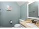 Cozy half bathroom featuring a granite countertop, framed mirror and decorative painting on the wall at 1701 Point Owoods Ct, Raleigh, NC 27604