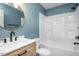Bathroom featuring updated vanity, mirror, lighting and tub-shower combination at 1701 Point Owoods Ct, Raleigh, NC 27604