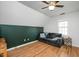 Bedroom featuring hardwood floors, ceiling fan, and a double-hung window at 1701 Point Owoods Ct, Raleigh, NC 27604