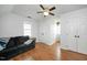 Bedroom featuring hardwood floors, ceiling fan, and a double-hung window at 1701 Point Owoods Ct, Raleigh, NC 27604