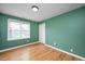 Bedroom featuring hardwood floors, neutral paint and a large double-hung window at 1701 Point Owoods Ct, Raleigh, NC 27604