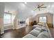 Bedroom featuring hardwood floors, built-in shelves, and a ceiling fan at 1701 Point Owoods Ct, Raleigh, NC 27604