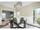 Dining room with natural light, complemented by modern lighting and views into the living room at 1701 Point Owoods Ct, Raleigh, NC 27604