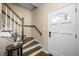 Warm and inviting entryway with hardwood stairs, a decorative table, and natural light at 1701 Point Owoods Ct, Raleigh, NC 27604