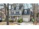 Charming two-story home featuring a front porch, attached garage, dormer windows, and traditional design elements at 1701 Point Owoods Ct, Raleigh, NC 27604