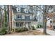 Charming two-story home with a welcoming front porch and well-manicured landscaping at 1701 Point Owoods Ct, Raleigh, NC 27604