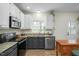 Stylish kitchen featuring granite countertops, modern appliances, and ample cabinet space at 1701 Point Owoods Ct, Raleigh, NC 27604