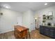 Kitchen area featuring wooden flooring, an island with multiple drawers and storage, and a beverage center at 1701 Point Owoods Ct, Raleigh, NC 27604