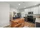 Updated kitchen featuring granite countertops, stainless steel appliances, island and white and grey cabinetry at 1701 Point Owoods Ct, Raleigh, NC 27604