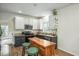 Bright kitchen featuring granite countertops, stainless appliances, an island with seating and stylish cabinetry at 1701 Point Owoods Ct, Raleigh, NC 27604