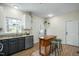 Well-lit kitchen with dark cabinets, stainless appliances, and a butcher block island at 1701 Point Owoods Ct, Raleigh, NC 27604