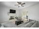 Bright living room with a fireplace, ceiling fan and a seamless flow into the dining area at 1701 Point Owoods Ct, Raleigh, NC 27604