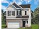 Charming two-story home features a brick base, gray siding, and attached two car garage at 184 Bruce Dr, Dunn, NC 28334