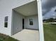 Covered patio space with light-colored vinyl siding and two windows at 184 Bruce Dr, Dunn, NC 28334