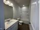 Bathroom with a shower-tub, tile flooring, modern vanity, and brushed nickel fixtures at 184 Bruce Dr, Dunn, NC 28334