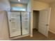 Modern bathroom features a glass enclosed shower and convenient access to a storage area with shelving at 184 Bruce Dr, Dunn, NC 28334