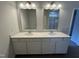 Bathroom featuring a double sink vanity with large mirrors and tiled flooring at 184 Bruce Dr, Dunn, NC 28334