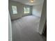Bright bedroom with two windows and neutral carpeted flooring at 184 Bruce Dr, Dunn, NC 28334