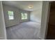 Spacious bedroom with plush carpet and plenty of natural light from two windows offers a relaxing retreat at 184 Bruce Dr, Dunn, NC 28334