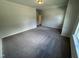 A large bedroom with neutral carpeting and plenty of space is bathed in natural light from the window at 184 Bruce Dr, Dunn, NC 28334
