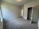 Bedroom featuring neutral carpet, natural light, and a double-door closet at 184 Bruce Dr, Dunn, NC 28334