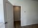 Walk-in closet with white wire shelving, light walls, and modern wood-look flooring at 184 Bruce Dr, Dunn, NC 28334