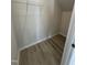 Walk-in closet with wire shelving and wood-look flooring at 184 Bruce Dr, Dunn, NC 28334